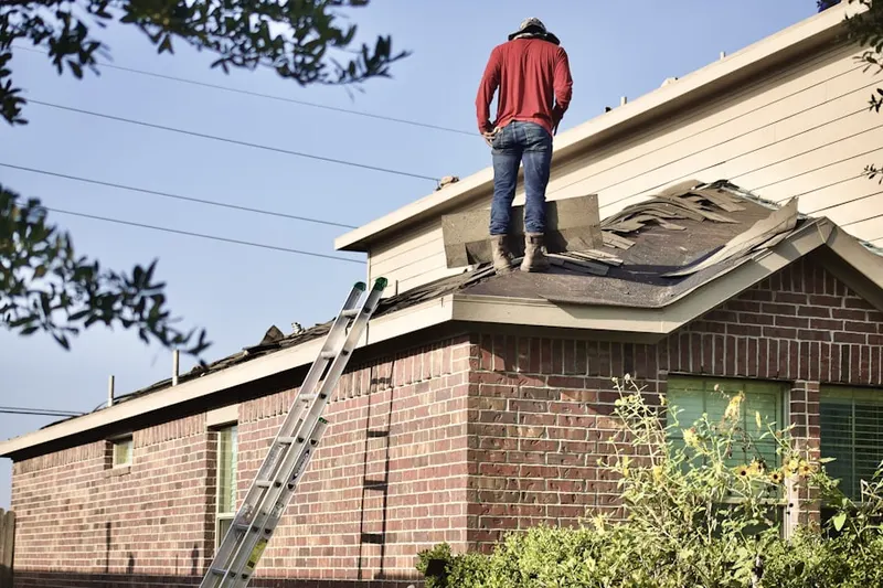 Professional roofer working on a residential roof in West Oak Hill